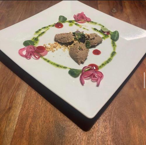a plate with a necklace of flowers on a table at Hotel Taurus in Ostrava