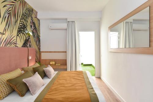 En eller flere senger på et rom på Apartamento Deluxe en Cruce de Arinaga GRANEL