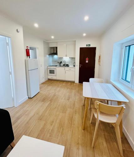 a kitchen and dining room with a table and chairs at Casa Martins Country Apt, No.6 in Freiria