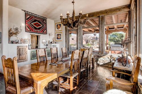 a dining room with a wooden table and chairs at El Otro Mundo in Santa Fe