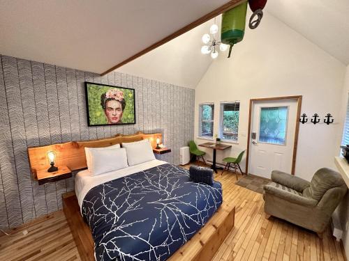a bedroom with a bed and a chair in it at Great Cabin In Close To Walking Trails And Beaches - 13t in Ucluelet
