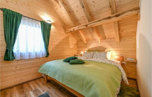 a bedroom with a bed in a log cabin at Awesome Home In Lovrecan With Sauna in Lovrečan
