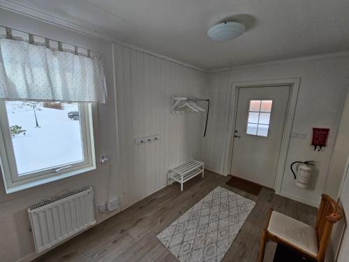 a white room with a window and a door at Romme stugby in Borlänge
