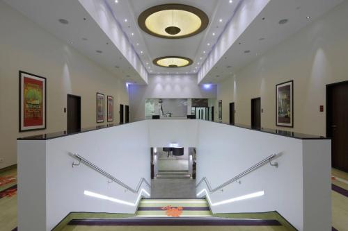 a staircase in a building with a white wall at Courtyard by Marriott Bremen in Bremen