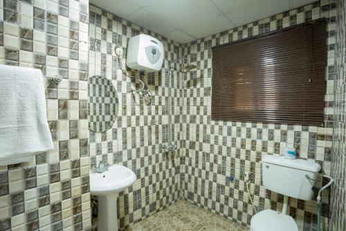 a bathroom with a toilet and a sink at VIDDOSH RESIDENCE in Ibadan