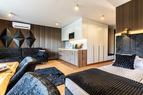 a hotel room with a bed and a living room at Aparthotel Diamond SPA Aqua in Białka Tatrzanska