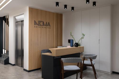 an office with a reception desk and two chairs at Nema Hotel Athens in Athens