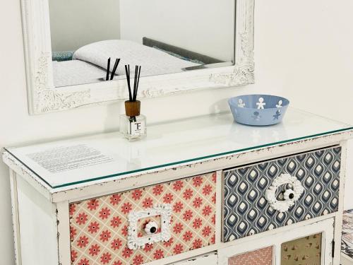a white dresser with a mirror on top at Residence Annunziata in Gaeta