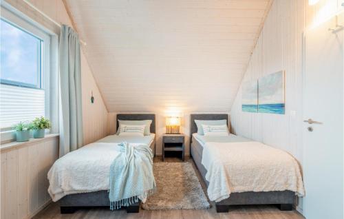 2 Betten in einem Zimmer mit Fenster in der Unterkunft Kuschelhaus in Olpenitz