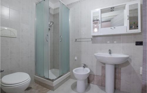 a bathroom with a toilet and a sink and a shower at 1 Bedroom Awesome Apartment In Catanzaro Lido in Catanzaro Lido