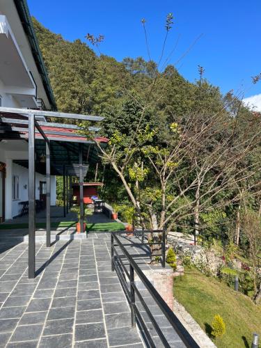 a building with a fence next to a sidewalk at Nagarkot Resort PVt. Ltd in Nagarkot