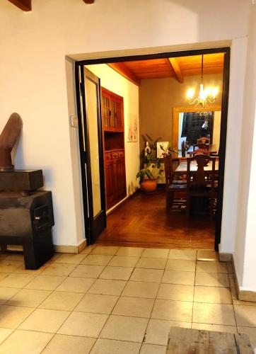 an open door to a dining room with a table at Hostel Tandil in Tandil
