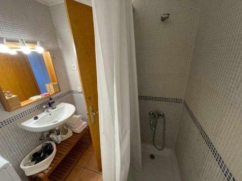 a bathroom with a sink and a toilet and a shower at Galdana Apartamento con piscina in Cala en Blanes