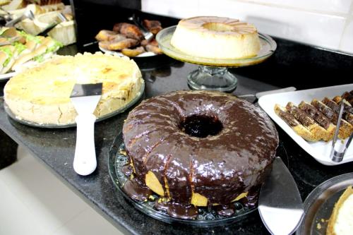 a table topped with different types of cakes and pies at Pousada Litoral Paraty in Paraty