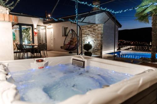 a jacuzzi tub in the backyard of a house at Villa View Mostar with Jacuzzi & Heated Pool in Mostar