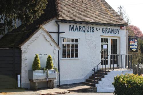 a small white building with a sign on it at The Marquis of Granby in Alkham