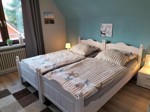 a bedroom with a bed with two pillows on it at Ferienwohnung Am Ems-Seitenkanal 65353 in Moormerland