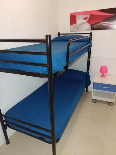 - une chambre avec 2 lits superposés et des draps bleus dans l'établissement Mare Chiaro, à Campese