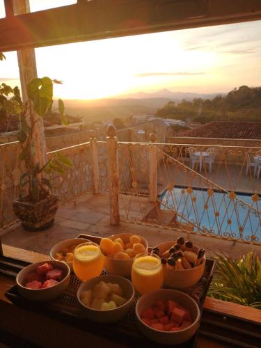 a tray of fruit on a table with a view at Hotel Montanhas de Minas in Diamantina