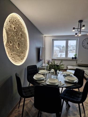 a dining room with a table and chairs at Apartament Księżycowy Wisła in Wisła