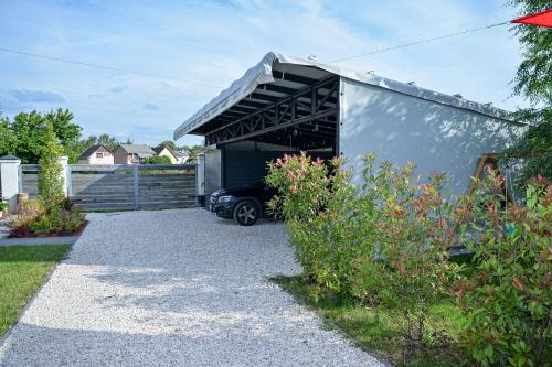 a garage with a car parked inside of it at Földi Paradicsom Vendégház in Hajdúszoboszló