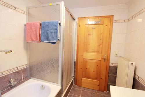 a bathroom with a shower and a sink and a tub at 4 Barga Blick in Partenen