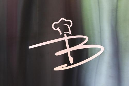 a white sign with a sword on a curtain at Hotel Baldus in Delmenhorst