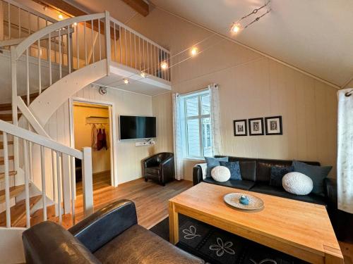 a living room with a couch and a staircase at Hamn i Senja in Hamn
