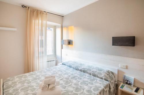 a bedroom with a bed and a window at Alla Marina Affittacamere in Riomaggiore