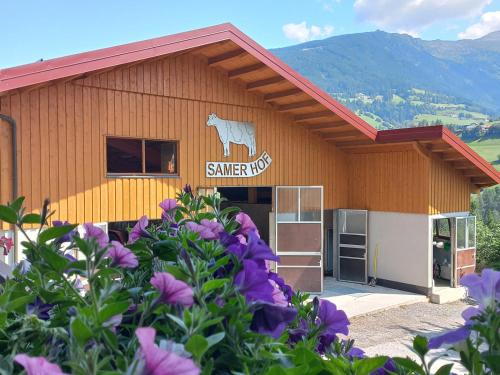 a building with a sign on it with a goat on it at Ferien am Samerhof in Matreiwald
