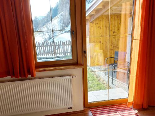 an open window with a view of a balcony at Ferien am Samerhof in Matreiwald