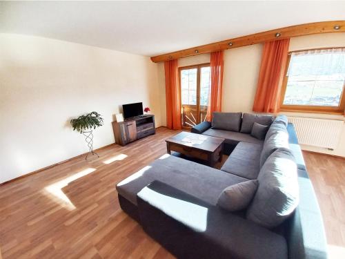 a living room with a couch and a table at Ferien am Samerhof in Matreiwald