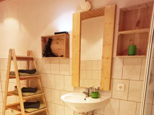 a bathroom with a sink and a mirror at Ferien am Samerhof in Matreiwald