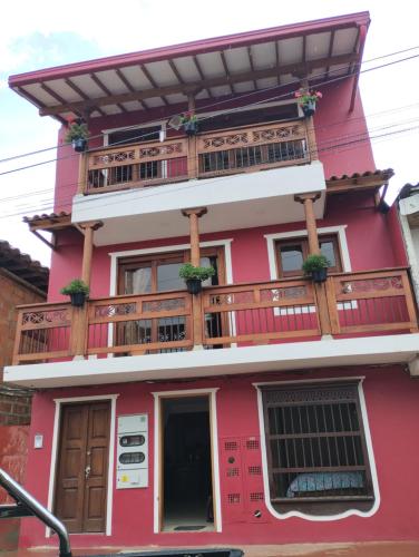a red building with a balcony on it at Montesco in Jardin