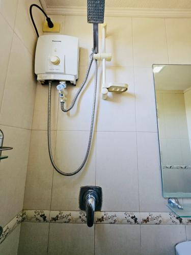 a shower in a bathroom with a mirror at Tropical Paradise @ One Oasis in Davao City+SM Davao in Davao City