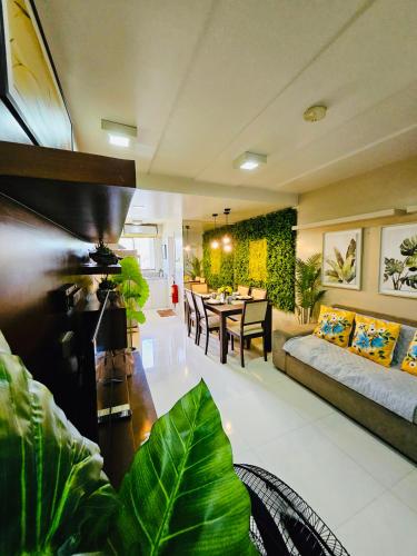 a living room with a couch and a table at Tropical Paradise @ One Oasis in Davao City+SM Davao in Davao City