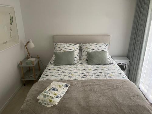 a bedroom with a bed with pillows on it at Un loft de charme dans une maison atelier in Paris