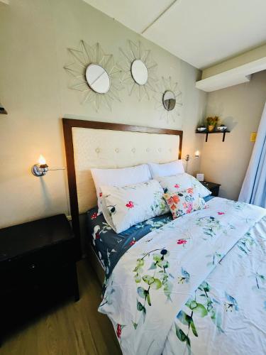 a bedroom with a bed and two mirrors on the wall at Tropical Paradise @ One Oasis in Davao City+SM Davao in Davao City