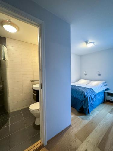 a bedroom with a bed and a bathroom with a toilet at Hamn i Senja in Hamn