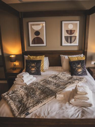 a bedroom with a bed with towels on it at Crossways in Wells