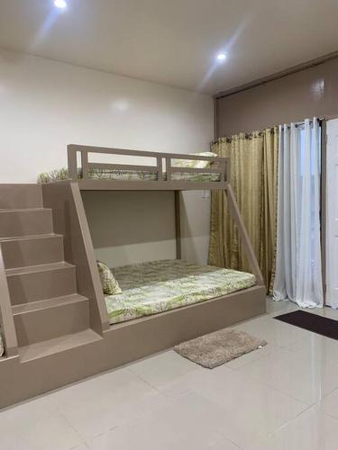 a bedroom with two bunk beds in a room at PMPJ Cabin in Lipa