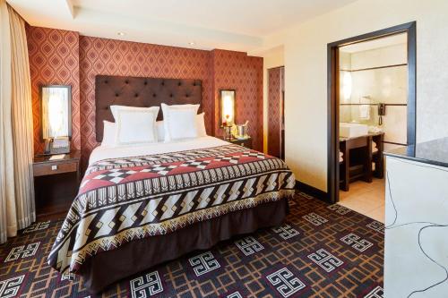 a hotel room with a bed and a bathroom at Miccosukee Casino & Resort in Miami