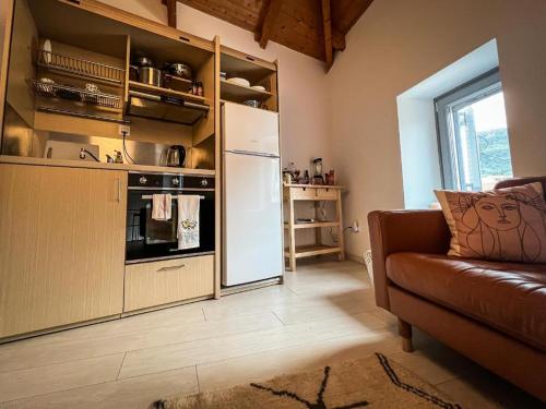 a kitchen with a refrigerator and a couch in a room at Old Town Studios in Parga