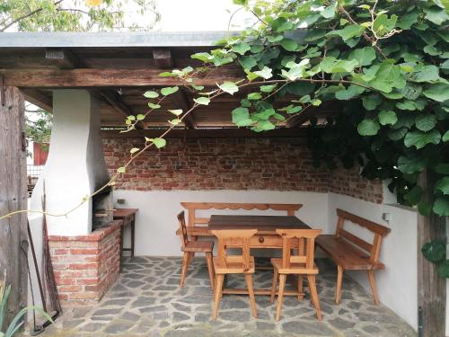 a wooden table and chairs on a patio at Landlust-Ferienhaus Am Rosenhof in Hartberg