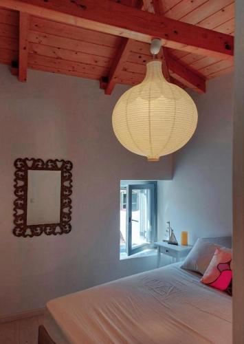 a bedroom with a lamp and a bed with a mirror at Old Town Studios in Parga