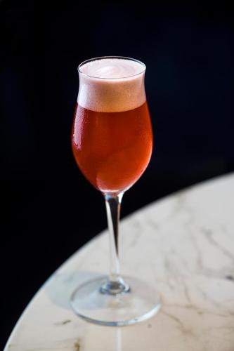 a glass of beer sitting on a table at InterContinental Barcelona by IHG in Barcelona