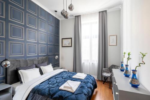 a bedroom with blue walls and a bed and a desk at NEW High-End 2BR Apartment with Parking in Sofia