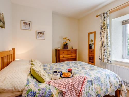 a bedroom with a bed and a table with food on it at 3 bed property in Bath 79174 in Chilcompton