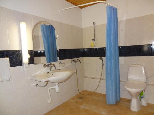 a bathroom with a sink and a toilet and a mirror at White Villa in Tallinn