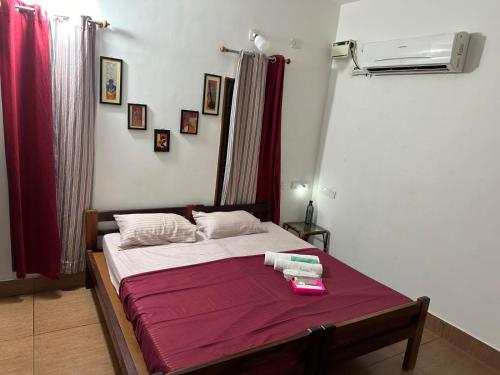 a bedroom with a bed with towels on it at Maass Homestay in Puducherry